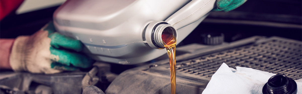 Mechanic pouring engine oil into a vehicle - Car Servicing Edenbridge