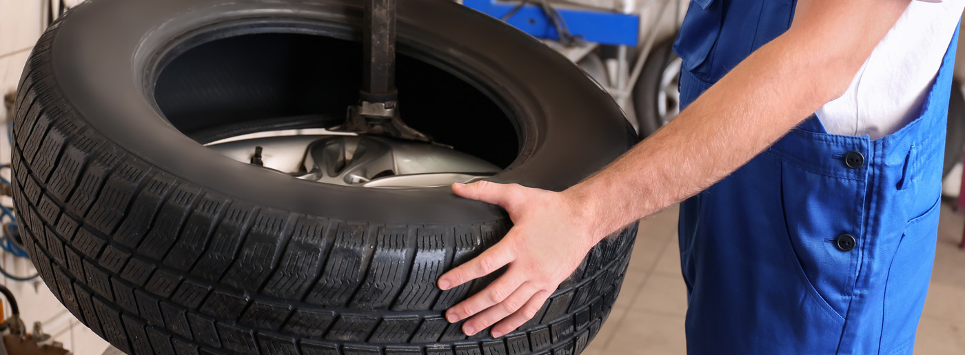Mechanic holding a tyre - Tyres Edenbridge