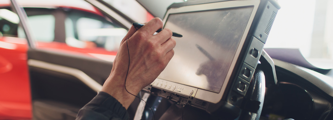 Mechanic checking a vehicle using diagnostic equipment - Car Diagnostics Edenbridge